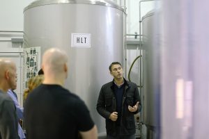 man giving a tour of the brewery