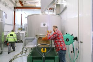 wide view of a man working inside the wily fox brewery in wigan
