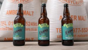 Wily Fox Karma Citra Bottle photos with bags of grain behind