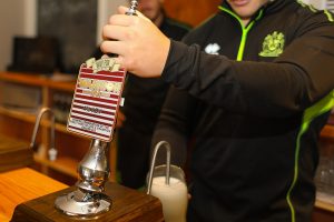 Rugby Player George Williams pulls a pint of the new Warrior IPA