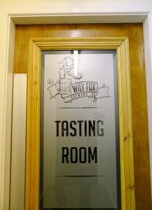 Wily Fox logo on the door to the tasting room