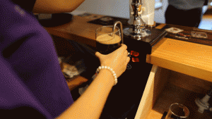 Animated giff of the bar maid pulling a pint of black pearl IPA